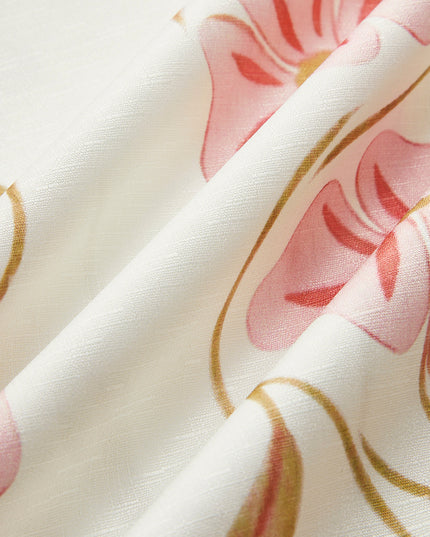 Close-up of the fabric texture of the white summer floral mini dress with pink and gold flower pattern.