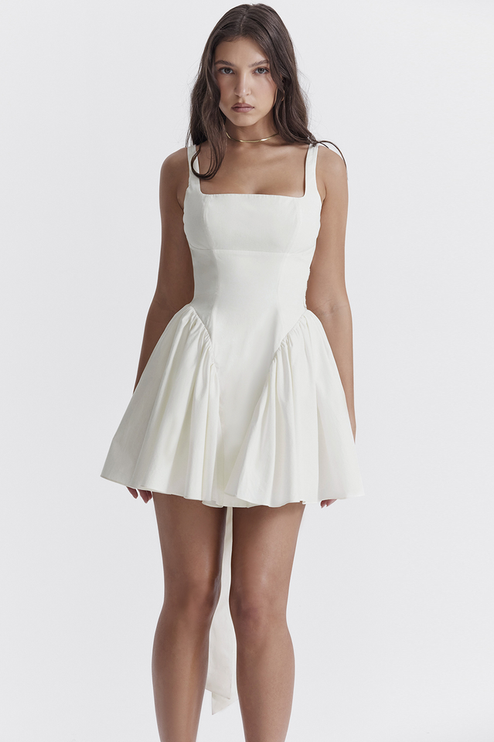 Close-up front view of the white square neck mini dress, emphasizing the structured bodice and flared skirt.