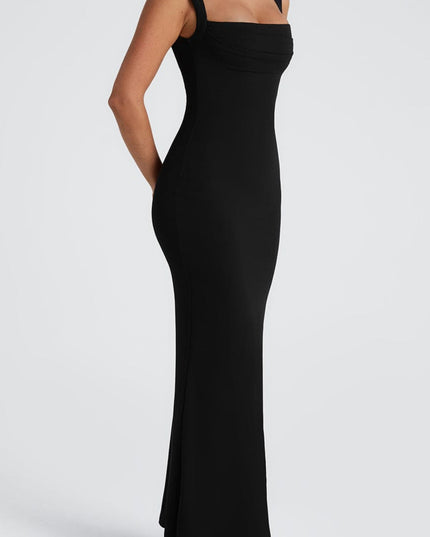 Side profile of the black maxi dress, emphasizing the elegant drape of the fabric and fit.