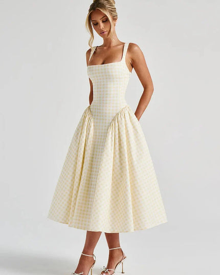 Women's light yellow gingham square neck midi dress with full skirt and fitted bodice, styled with white heels
