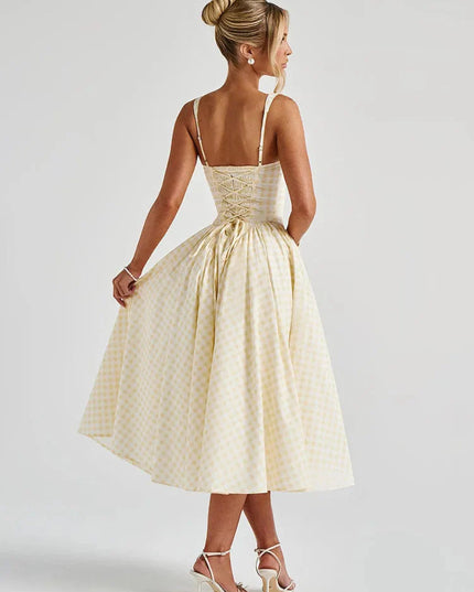 Back view of women's light yellow gingham midi dress, showing lace-up corset detail and full skirt