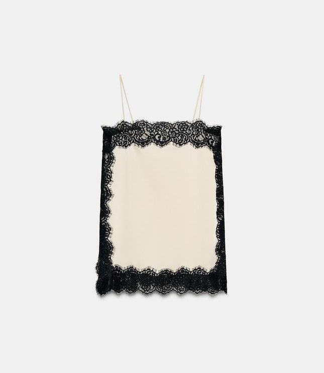 Flat lay of a cream satin camisole mini dress, showcasing the square neck and black lace trim on all edges.