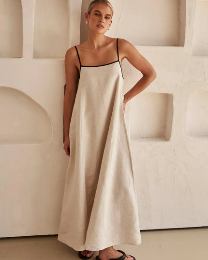 Side view of a light beige women's summer maxi dress with a relaxed fit and black trim.