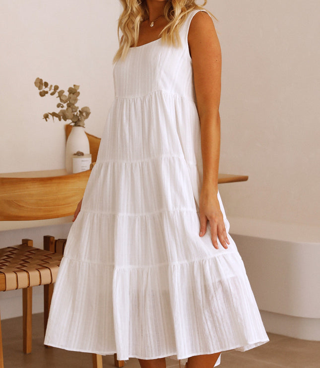 Elegant white square neck sleeveless tiered midi dress, for summer, shown in a relaxed indoor setting.