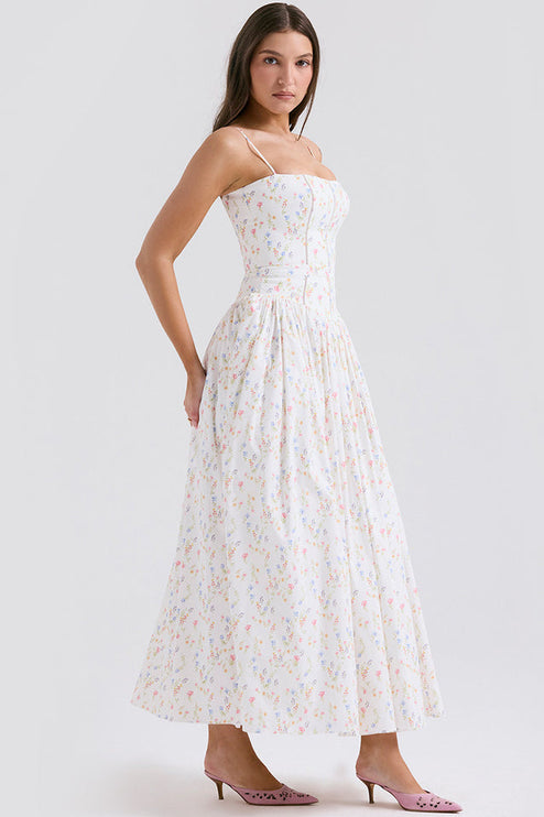 Side view of women's white floral print square neck midi dress, highlighting the fitted bodice and flowing skirt, with pink heels.