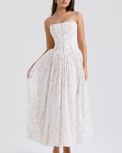 Women's white floral print square neck midi dress with delicate colorful flowers, structured bodice, and full skirt, with pink heels.