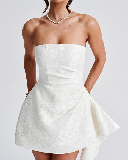 Close-up front view of the white floral strapless mini dress, highlighting the textured fabric and ruched bodice.