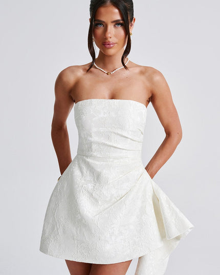 Front view close-up of the white floral strapless mini dress, emphasizing the textured pattern and neckline.