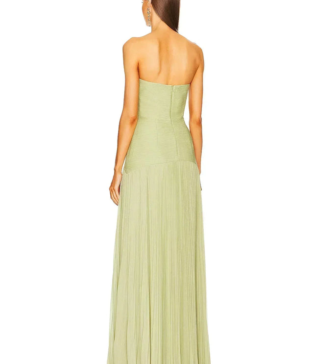 Rear view of a women's light green formal strapless maxi dress, highlighting the pleated details of the skirt.
