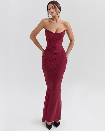 Front view of a deep red strapless ruched maxi dress, showcasing the fitted bodice and flowing sheer skirt.