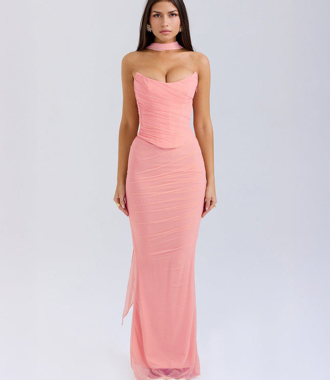 Full length view of a light pink strapless ruched maxi dress with a choker detail and sheer fabric overlay.