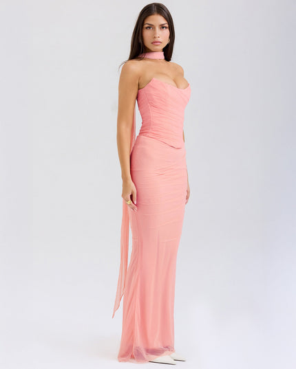 Side view of the light pink strapless ruched maxi dress, highlighting the long flowing sheer panel from the choker.