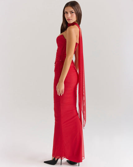 Back-side view of red strapless ruched maxi dress, highlighting the long sheer panel detail.