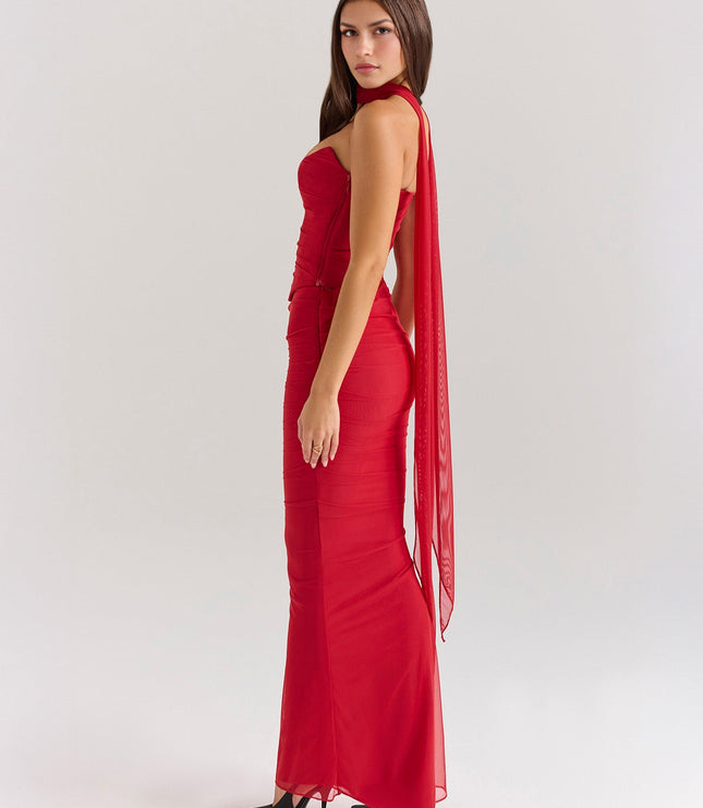 Back-side view of red strapless ruched maxi dress, highlighting the long sheer panel detail.