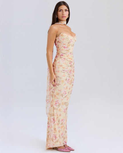 Side profile of the women's floral strapless ruched maxi dress, showcasing the floor-length skirt and ruched bodice detail.