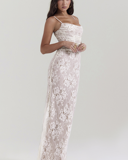 Side profile of white lace corset back strapless maxi dress, highlighting the fitted silhouette and subtle train.