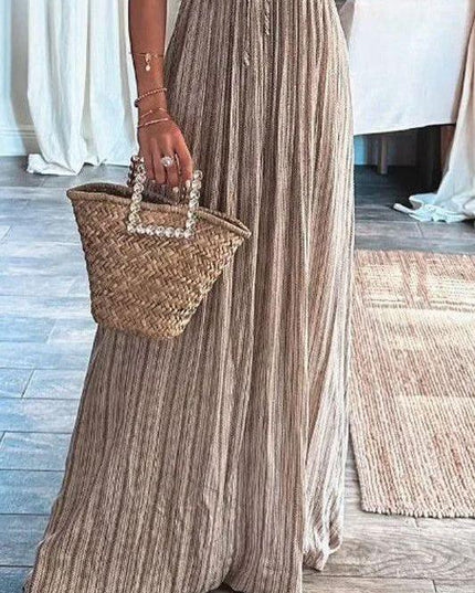 Close-up of the lower half of the women's striped maxi dress, highlighting the flowing skirt and vertical stripes.