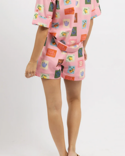 Back view of women's pink printed short sleeve short set, showing the full design and matching belt.