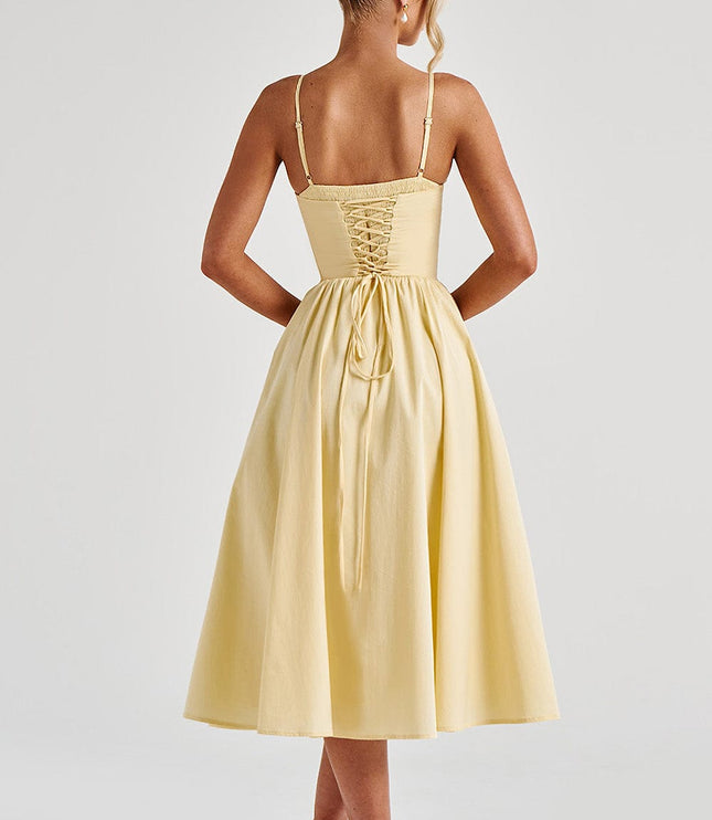 Back view of a light yellow sweetheart corset midi dress showing the lace-up detail and full skirt.