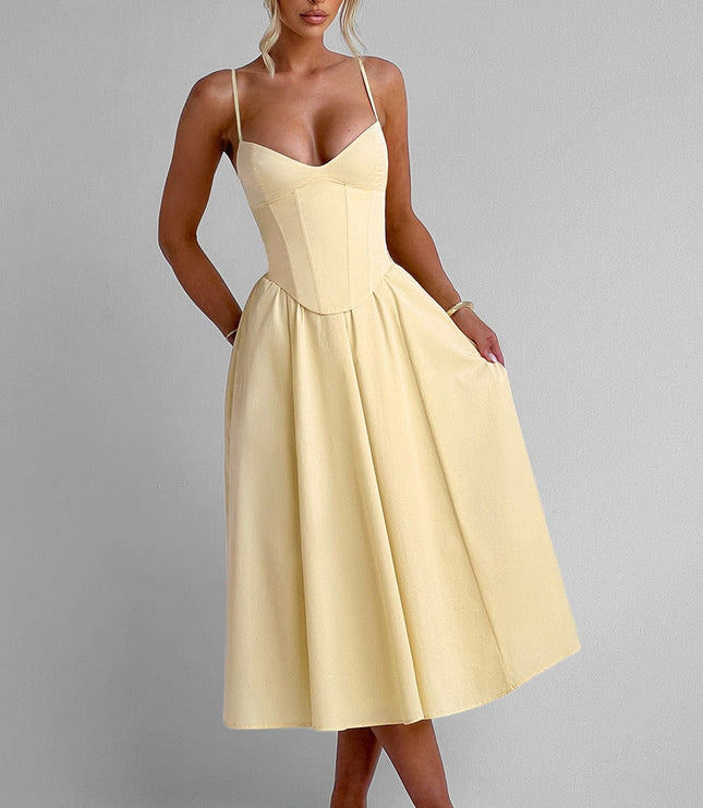 Front view of a light yellow sweetheart corset midi dress with spaghetti straps and a flowing skirt, paired with light heels.