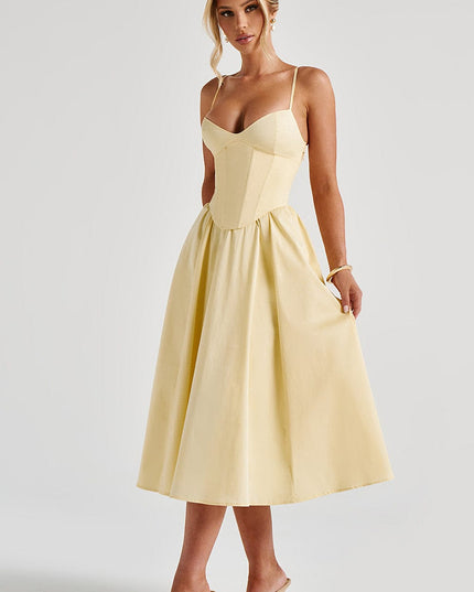 Side view of the light yellow sweetheart corset midi dress, highlighting the elegant silhouette and midi length.