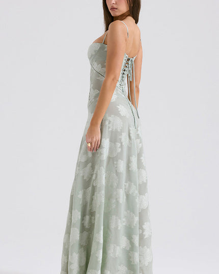 Three-quarter back view of women's sage green floral printed maxi dress with lace-up corset detail.