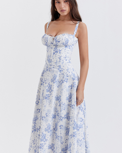 Side profile of women's white floral midi dress featuring a corset-style bodice and blue flower pattern