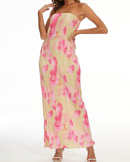 Side view of a women's strapless pleated maxi dress in a pink floral pattern, highlighting the flowy silhouette.