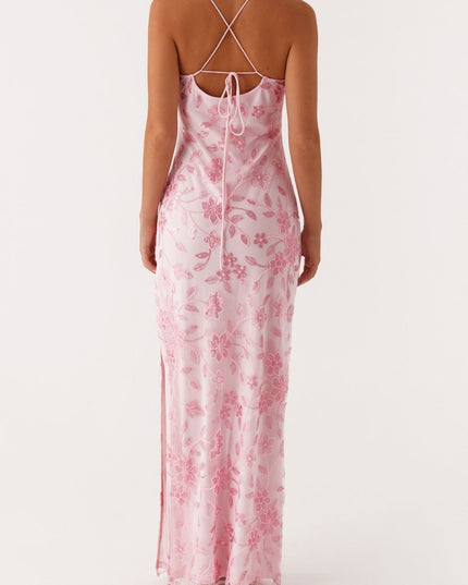 Back view of a pink floral maxi dress showing the tie-back detail and delicate beading on the fabric.