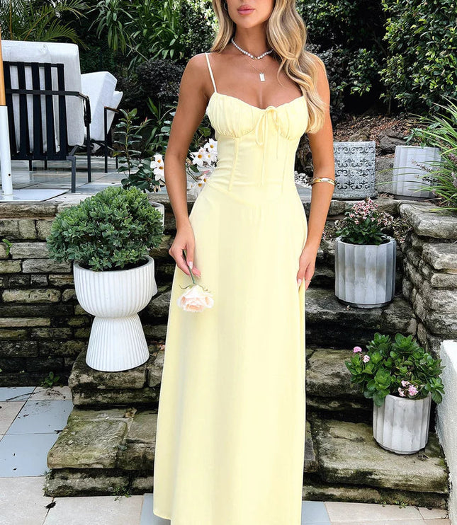 Full length view of a women's summer maxi dress in a delicate yellow hue, with a tie-front detail and subtle corset seaming.