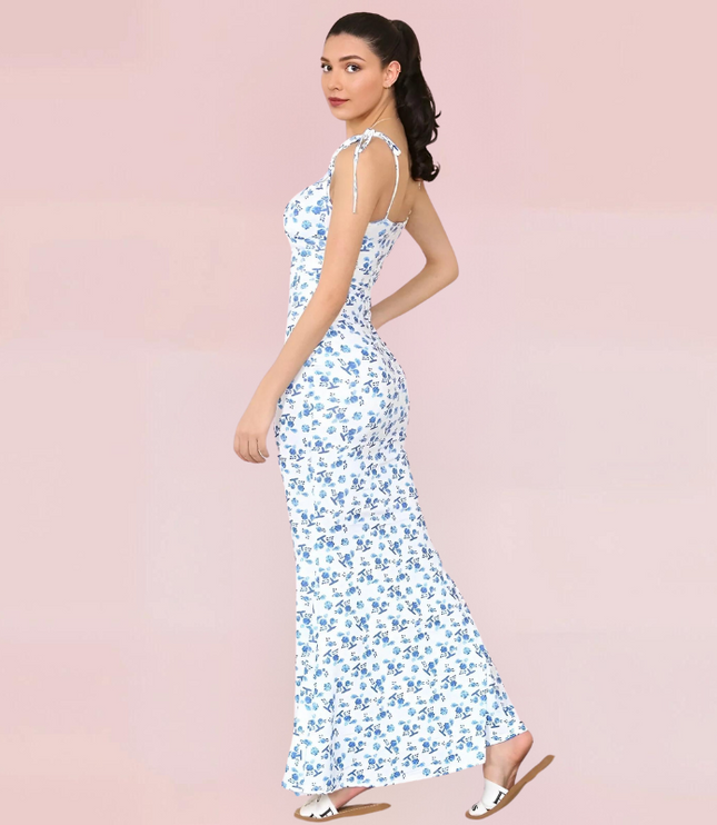 Women's white maxi dress with delicate blue floral print and tie-shoulder straps, side view