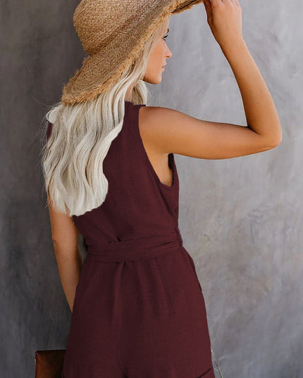 Back view of the women's burgundy sleeveless romper, showing the tie waist and cuffed shorts design.