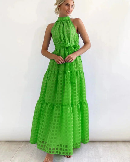 Bright green halter neck tiered maxi dress, showcasing a checkered pattern and a self-tie belt, for spring.