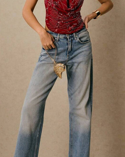 Full body shot of a women's red sequin halter deep V neck top, paired with wide-leg light wash jeans and heels.