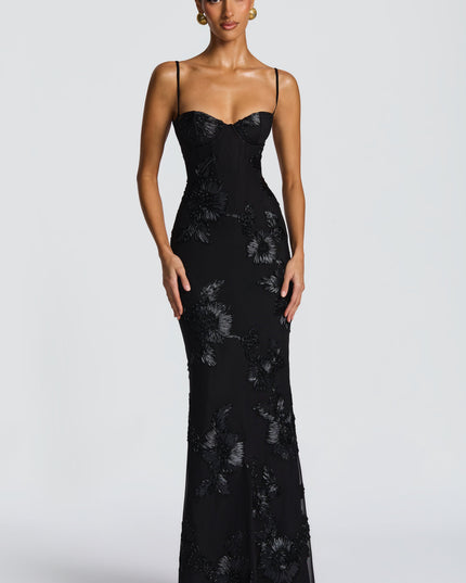 Front view of a black floral maxi dress featuring a sweetheart neckline and detailed floral embellishments throughout.