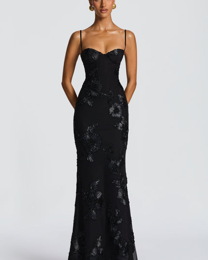 Full-length front view of a black floral maxi dress with thin straps and elegant floral patterns, ideal for formal occasions.
