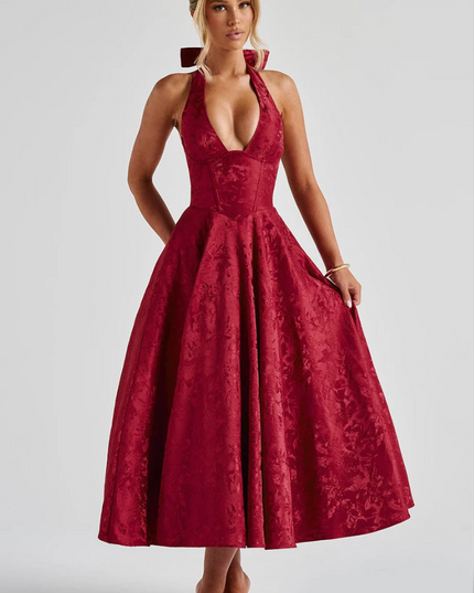 Red jacquard halter v-neck midi dress with a wide skirt and bow detail at the neck, front view.