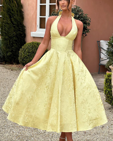 Yellow jacquard halter v-neck midi prom dress with full skirt and corset bodice detail, front view.