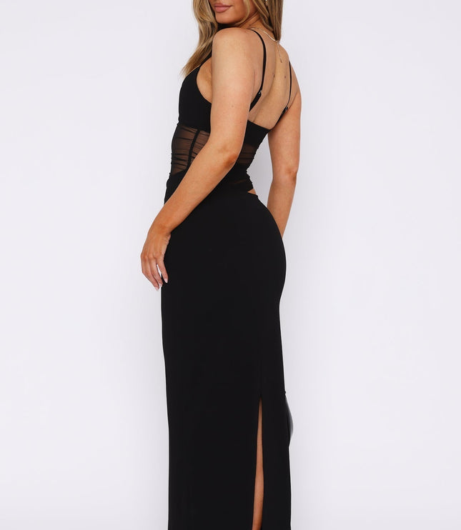 Back view of a black mesh cut-out V-neck maxi dress, highlighting the back slit and thin straps.