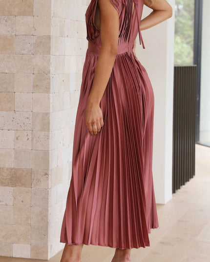 Back view of a women's rose pleated v-neck midi dress, highlighting the pleated details and a tie-back closure.