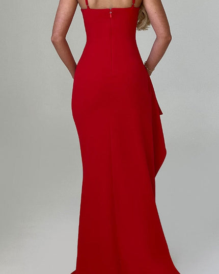 Back view of a red V-neck maxi dress with thin straps, featuring a subtle side ruffle detail.