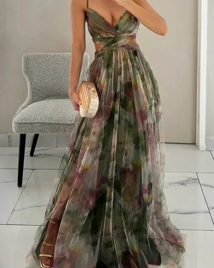 Women's green floral print maxi dress with V-neck and cut-out waist, holding a unique wood-look clutch, for wedding guests.