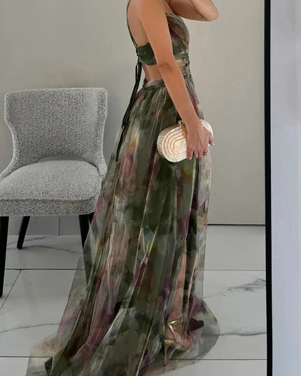 Side view of a women's green floral V-neck sleeveless maxi dress, showing the flowing skirt and back strap details.