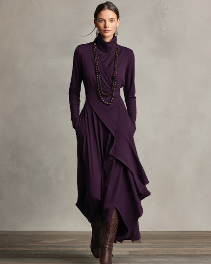 Front view of the plum long sleeve midi dress, showcasing the elegant drape and practical pockets, paired with boots.